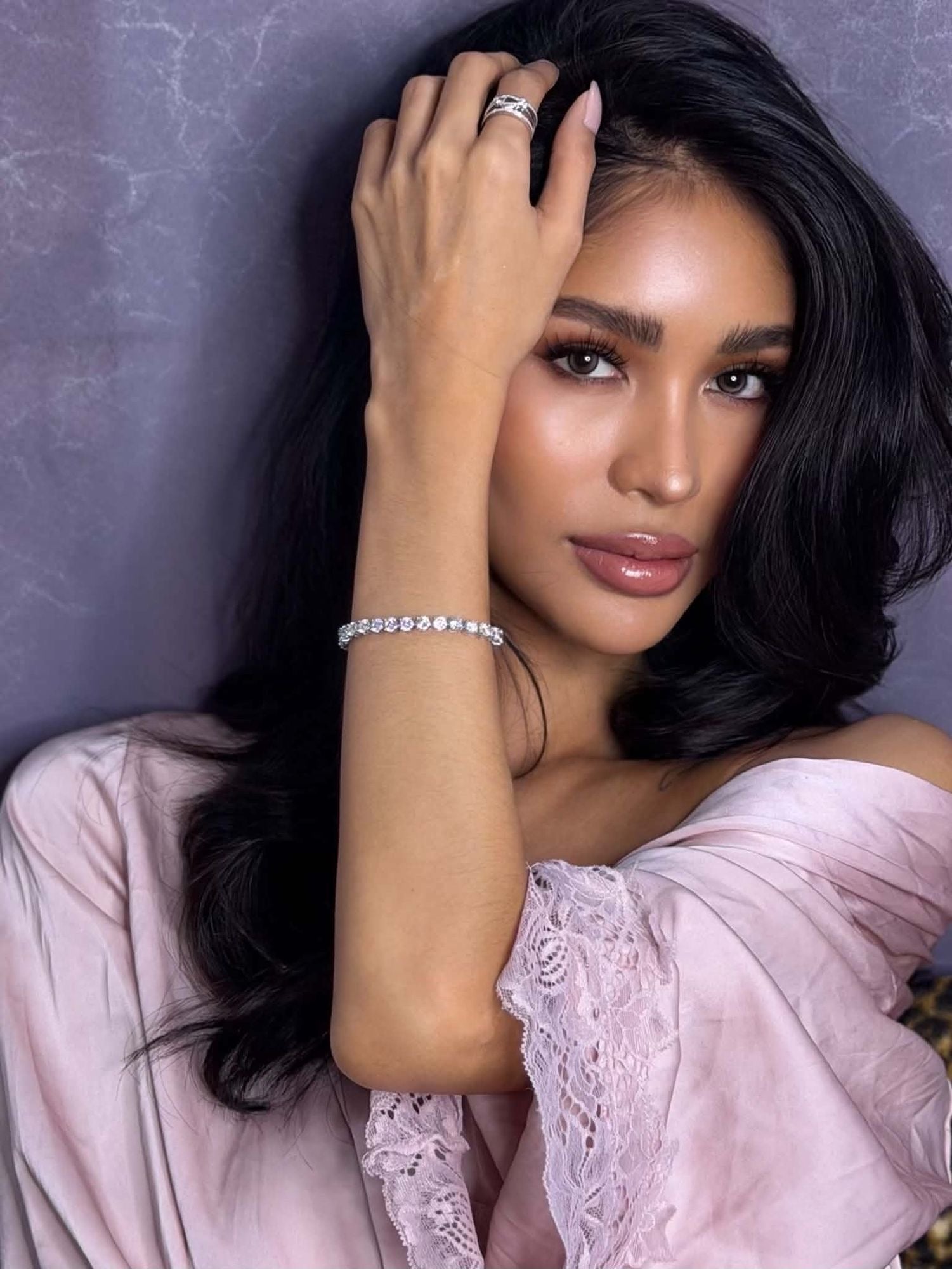 Veloura model wearing stacked rings and tennis bracelet