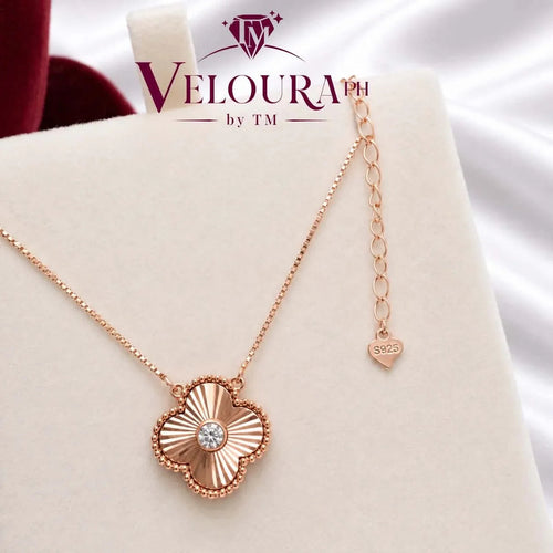 Rose-gold plated clover pendant in 925 silver with a radiating face and moissanite centre