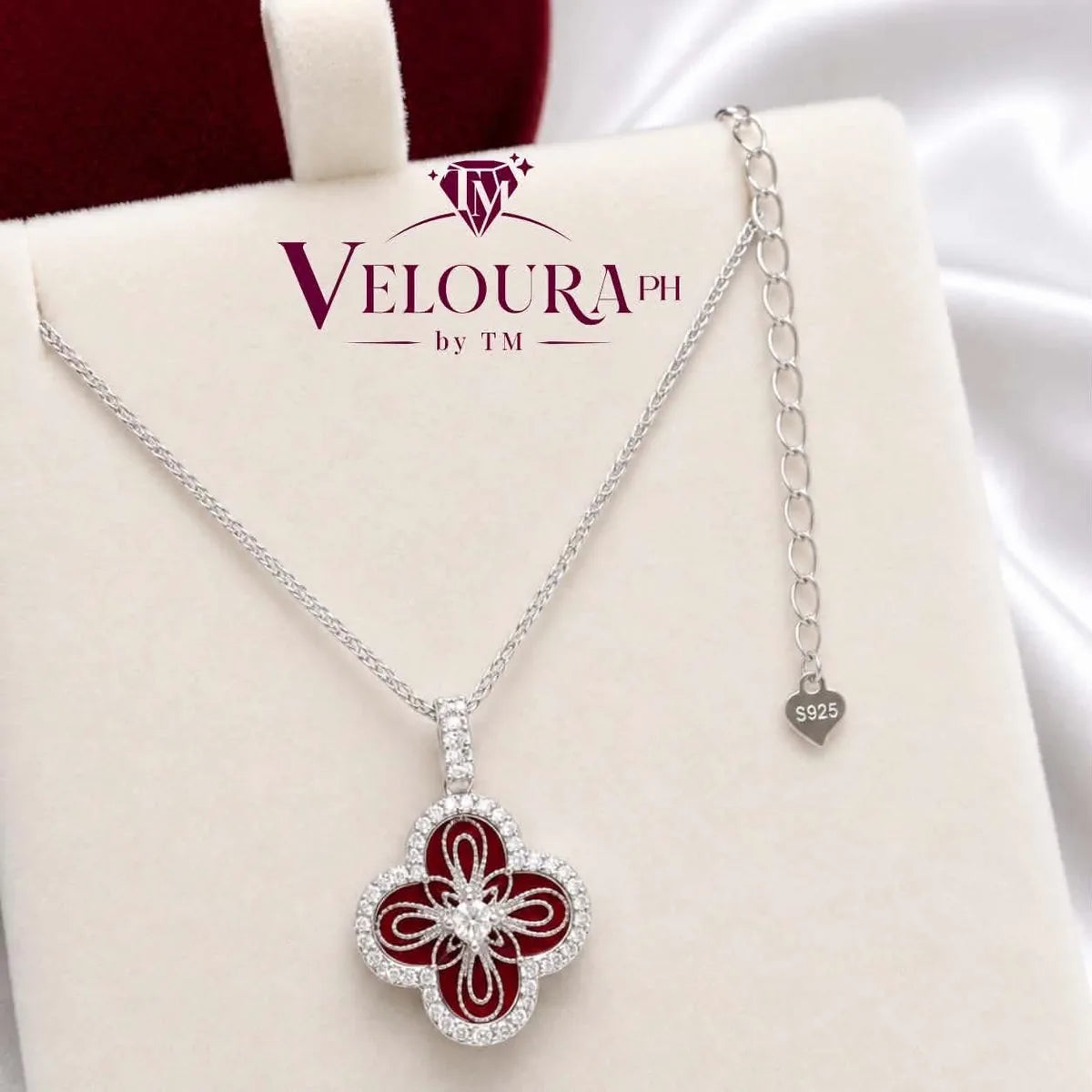 Quatrefoil clover pendant in 925 silver with red carnelian petals and a pavé frame
