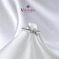 Infinity twist solitaire ring in 925 silver with a moissanite centre and crossover band