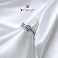 Cluster ring in 925 silver with an aqua-blue centre stone and moissanite accents