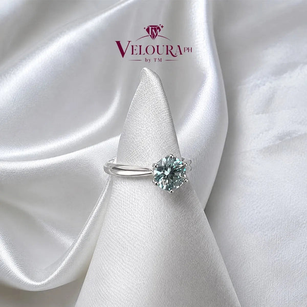 Round aqua-blue solitaire ring in 925 silver on a plain band