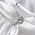 Round halo ring in 925 silver with a pavé band and moissanite centre