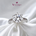 Round solitaire ring in 925 silver with channel-set moissanite shoulders