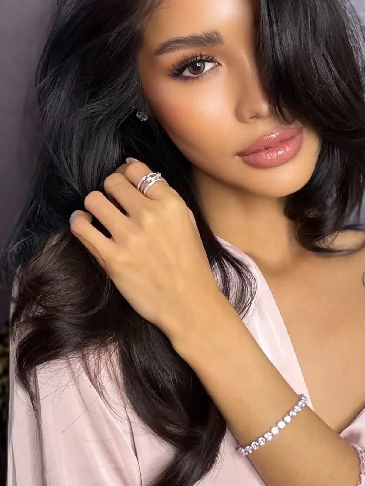 Veloura jewellery worn — rings and tennis bracelet